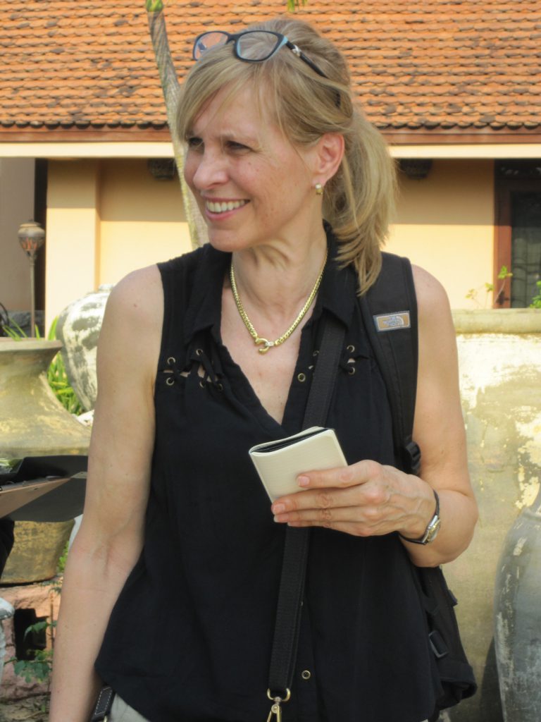 Margret hunting for new antiques in China with a notebook in her hand