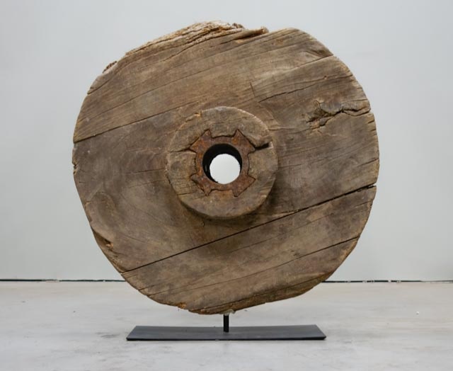 Rustic wooden wheel on metal base