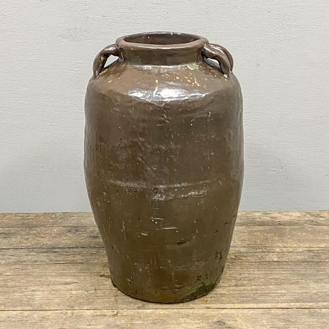 Single, tall, brown glazed pot with ears